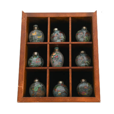 Collection of Chinese Reverse-Painted Snuff Bottles in a Display Case