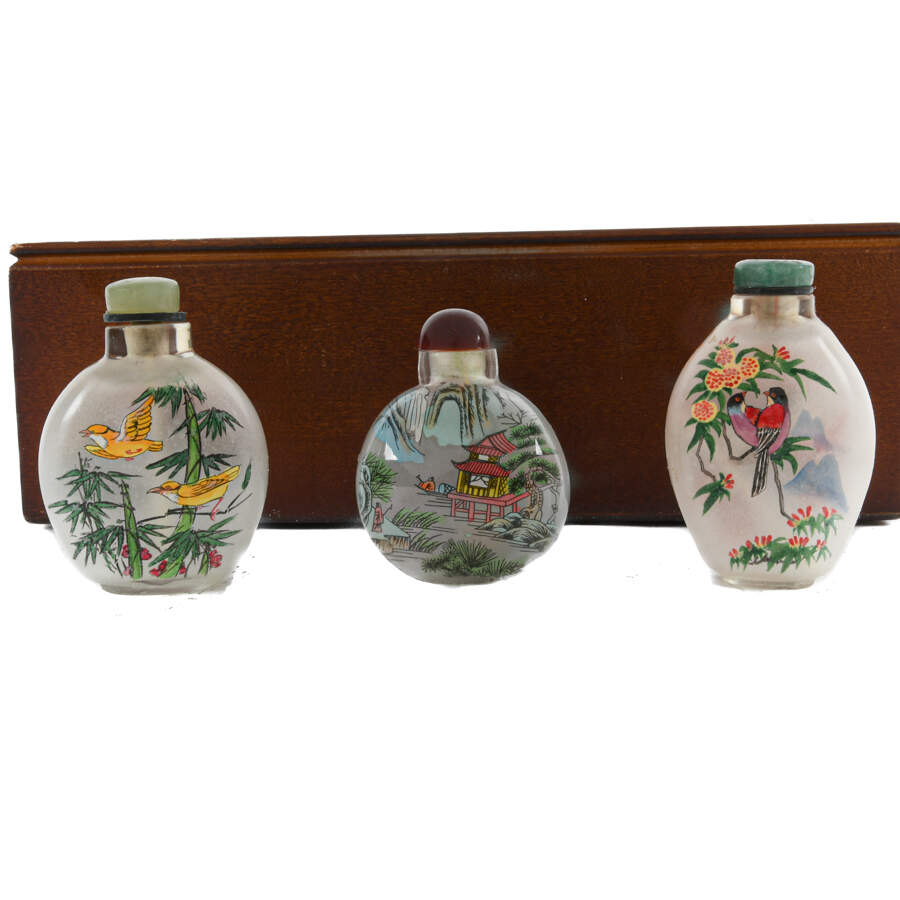Collection of Chinese Reverse-Painted Snuff Bottles in a Display Case-4
